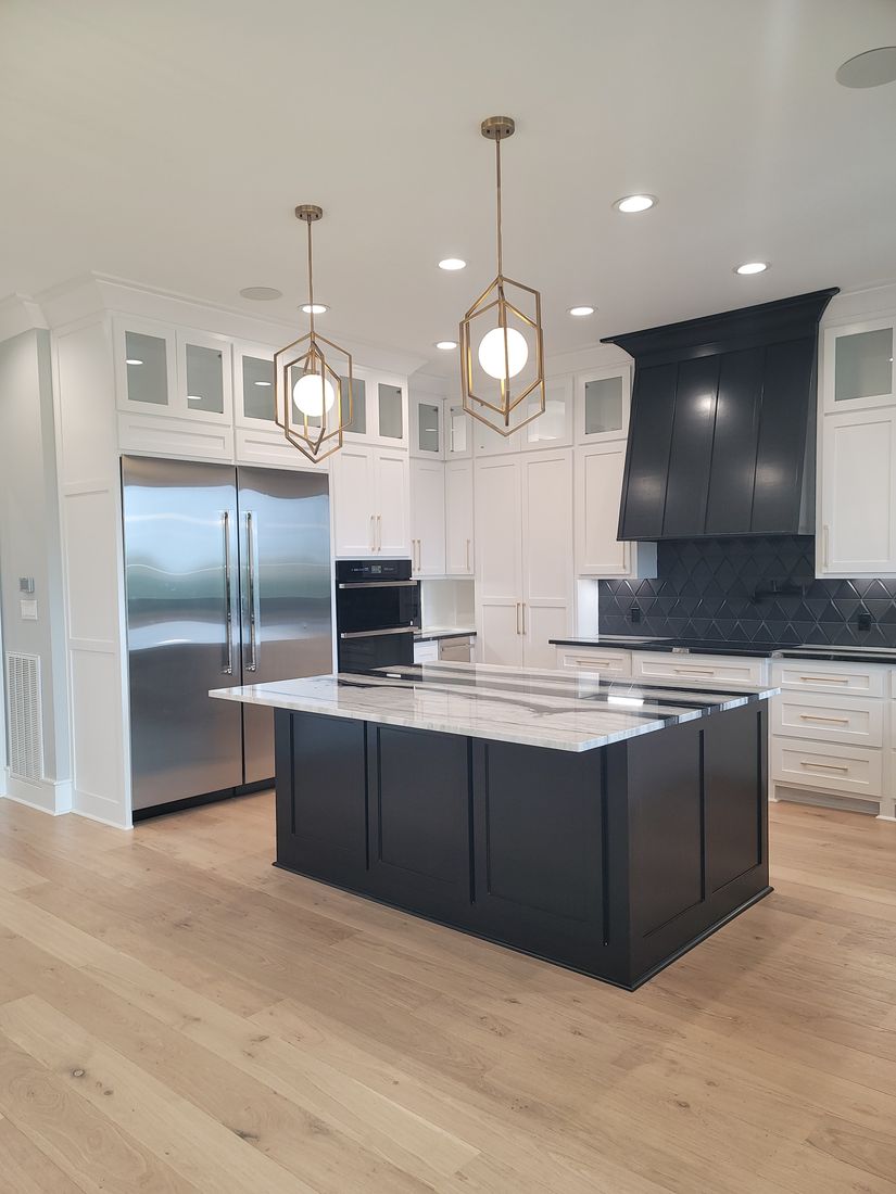 Completed Custom Residence Waterfall Quartzite Island and Custom Black Hood